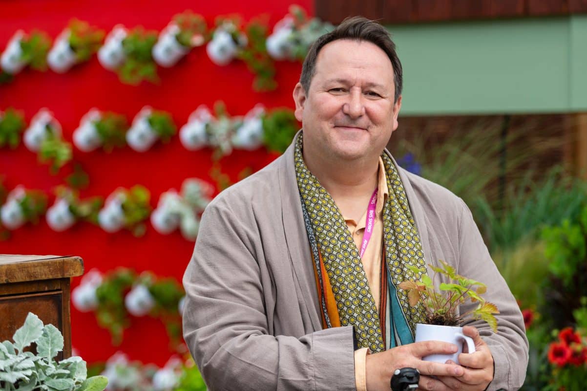 Photograph of Mark Lane with Gloria Hunniford and Gabby Roslin from the RHS-BBC Morning Live Budget-friendly Feature Garden at RHS Hampton Court Palace Garden Festival 2023, designed by Mark Lane from Mark Lane Designs Ltd